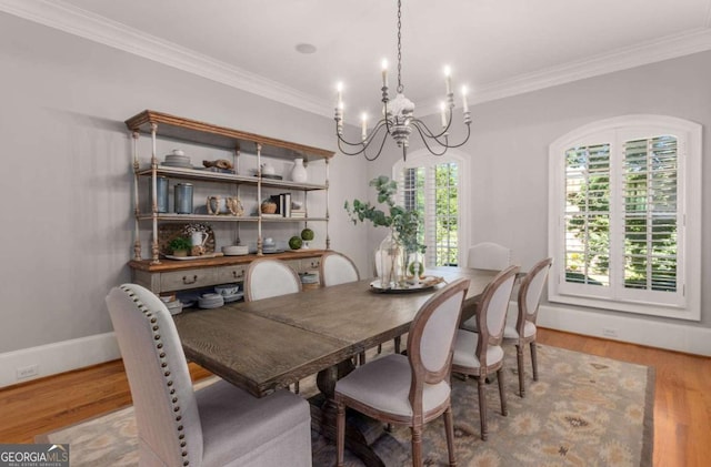 dining space with wood-type flooring and ornamental molding