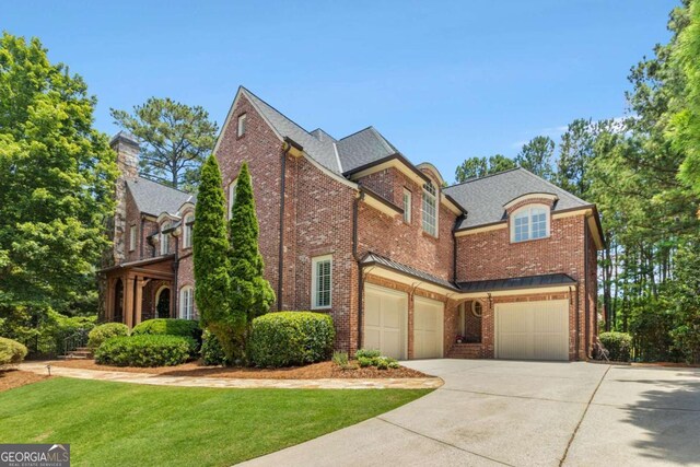 view of side of property with a garage and a yard