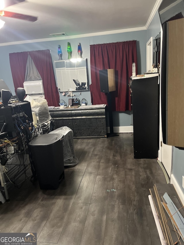 misc room featuring dark wood-type flooring, visible vents, and crown molding