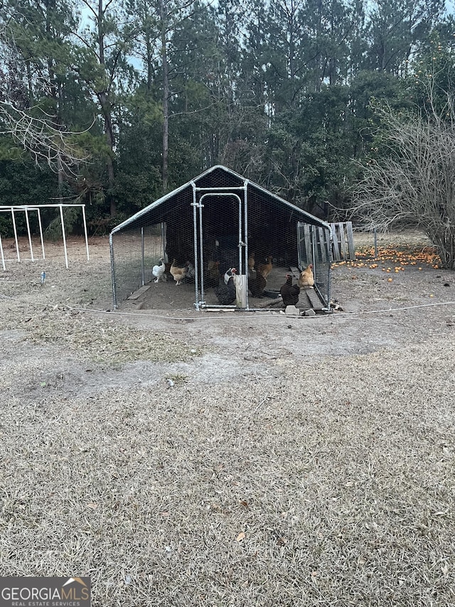 view of poultry coop featuring a detached carport