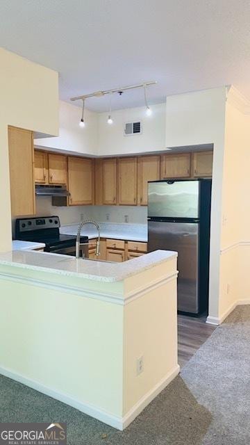 kitchen with sink, range with electric stovetop, stainless steel refrigerator, and kitchen peninsula