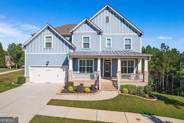 craftsman-style house with a garage, covered porch, and a front lawn