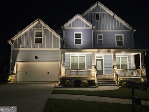 craftsman inspired home featuring a garage and covered porch