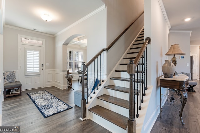 foyer entrance with hardwood / wood-style floors and crown molding