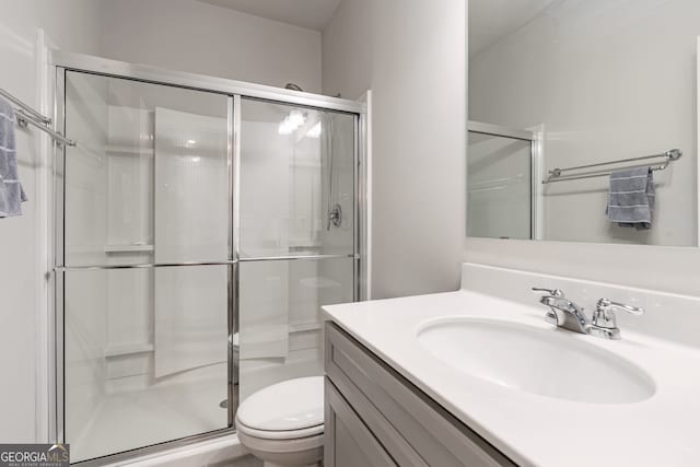 bathroom with vanity, toilet, and walk in shower