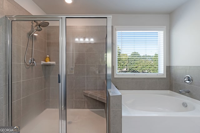 bathroom featuring independent shower and bath