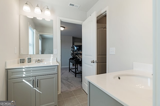 bathroom featuring tile patterned flooring and vanity