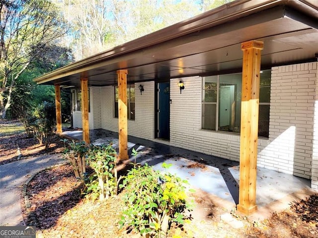 entrance to property featuring a patio area