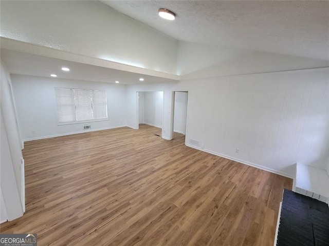 basement with a textured ceiling and light hardwood / wood-style flooring