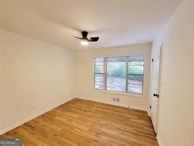 unfurnished room with light hardwood / wood-style flooring and ceiling fan