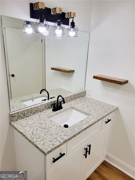 bathroom with vanity and hardwood / wood-style floors