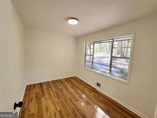 unfurnished room featuring wood-type flooring