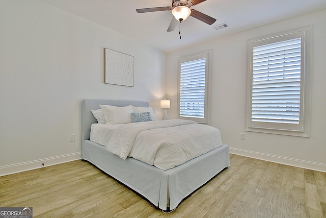 bedroom with ceiling fan and light hardwood / wood-style floors