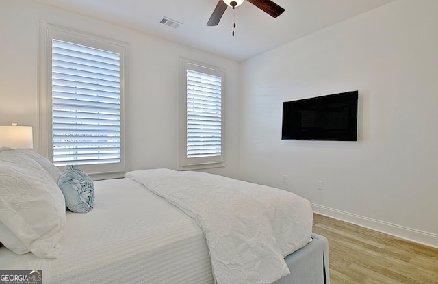 bedroom with light hardwood / wood-style floors and ceiling fan