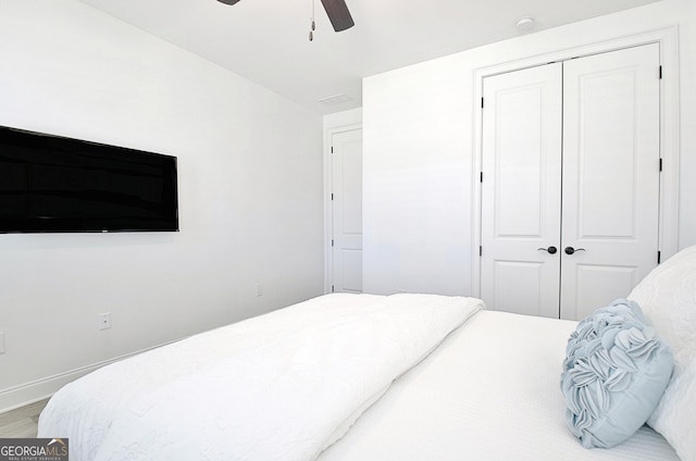 bedroom featuring hardwood / wood-style flooring, a closet, and ceiling fan