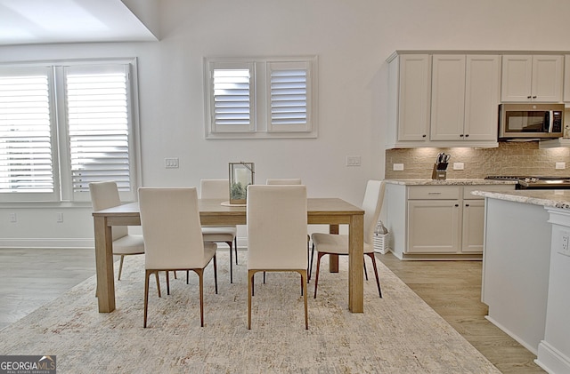 dining space featuring light wood-type flooring