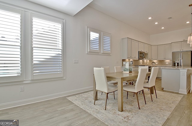 dining space featuring light wood-type flooring