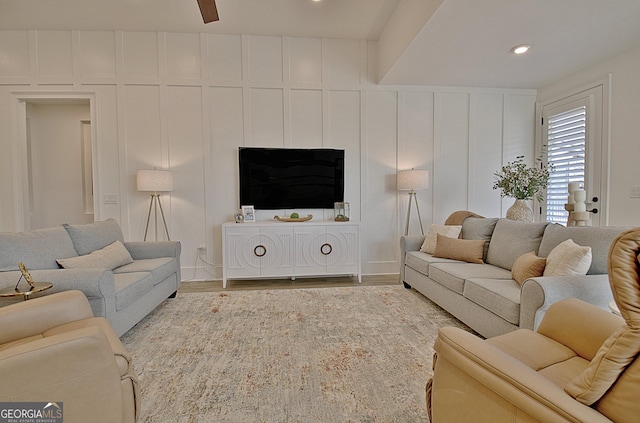 living room featuring ceiling fan and light hardwood / wood-style floors