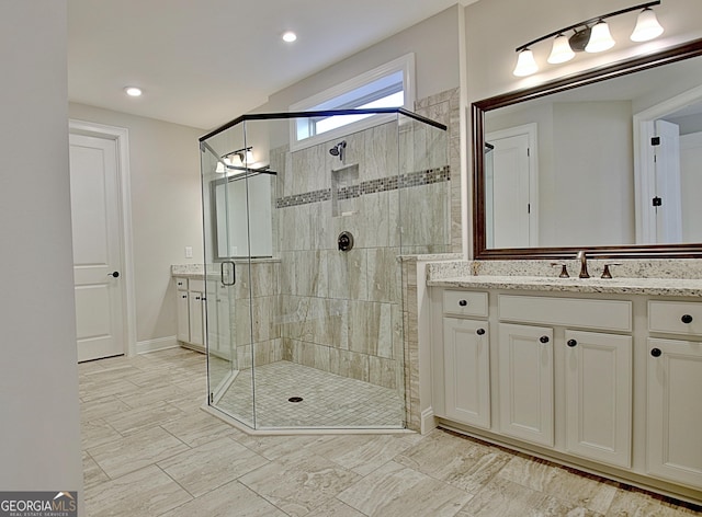 bathroom featuring vanity and a shower with shower door