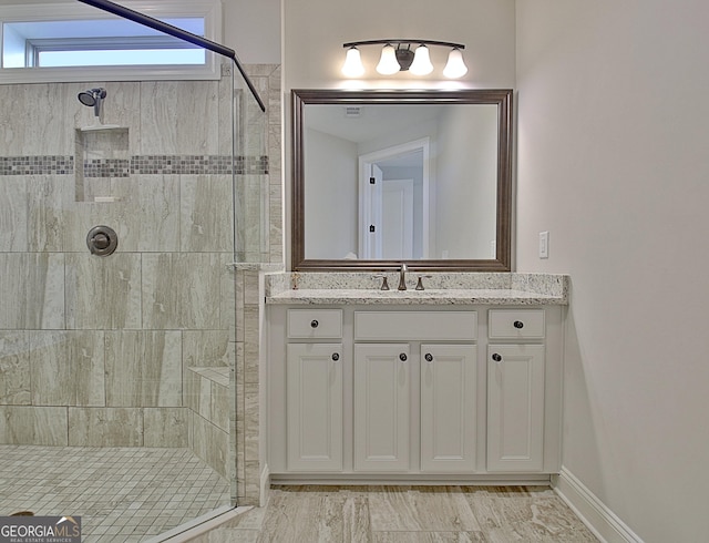 bathroom featuring an enclosed shower and vanity