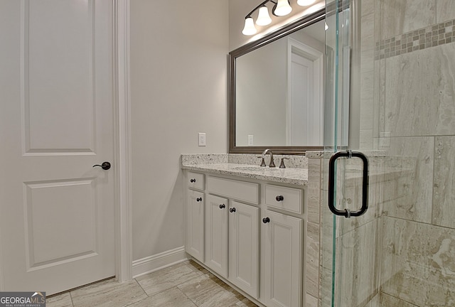 bathroom featuring vanity and a shower with door