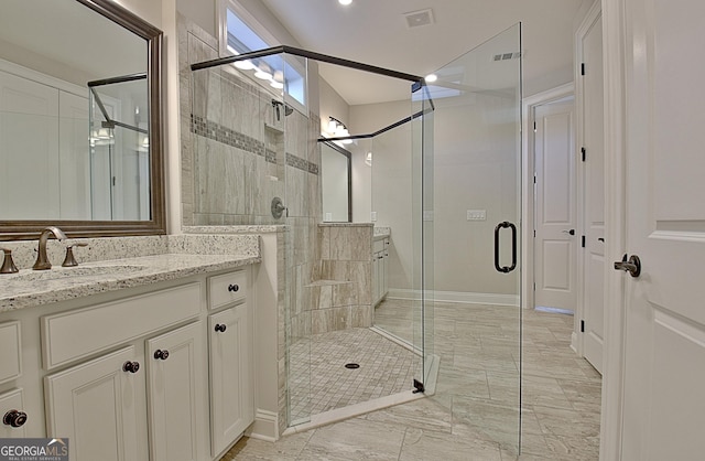 bathroom with vanity and a shower with shower door