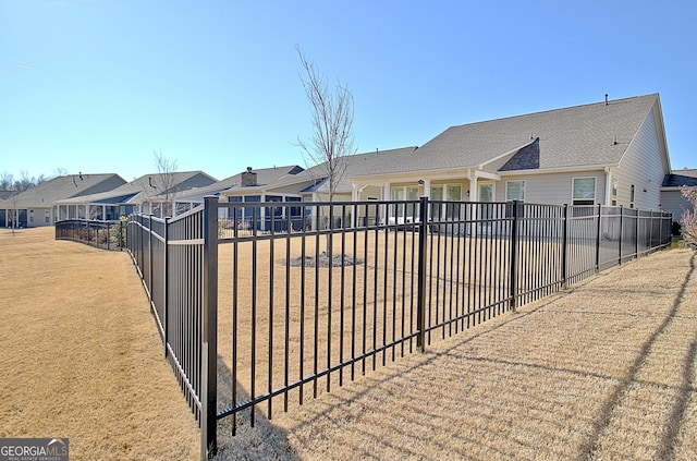 view of gate with a lawn