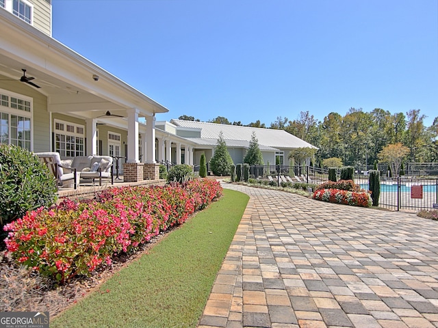 view of property's community with a patio, a swimming pool, and an outdoor hangout area