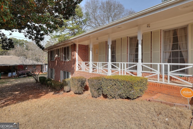 view of side of home featuring a porch