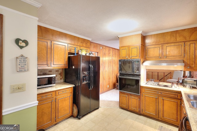 kitchen featuring ornamental molding, sink, a textured ceiling, and black appliances