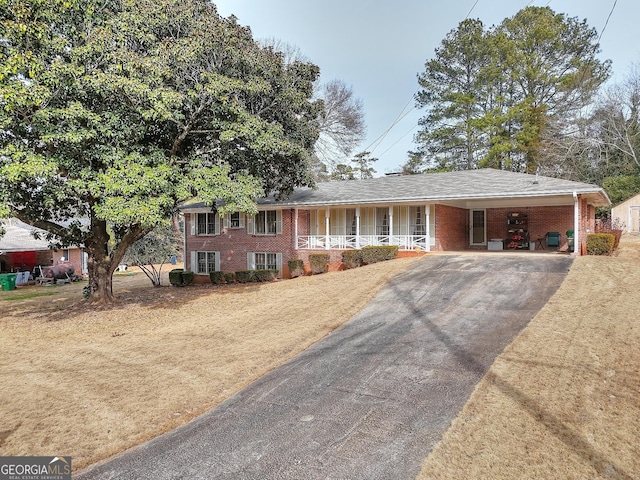 view of front of home with a carport and covered porch