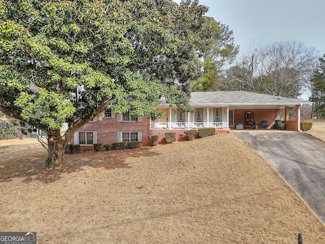 view of front of property with a carport and a porch