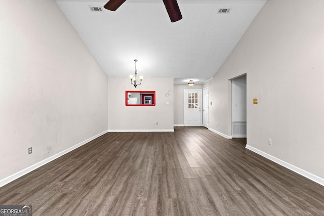 unfurnished living room with ceiling fan with notable chandelier, vaulted ceiling, and dark hardwood / wood-style floors