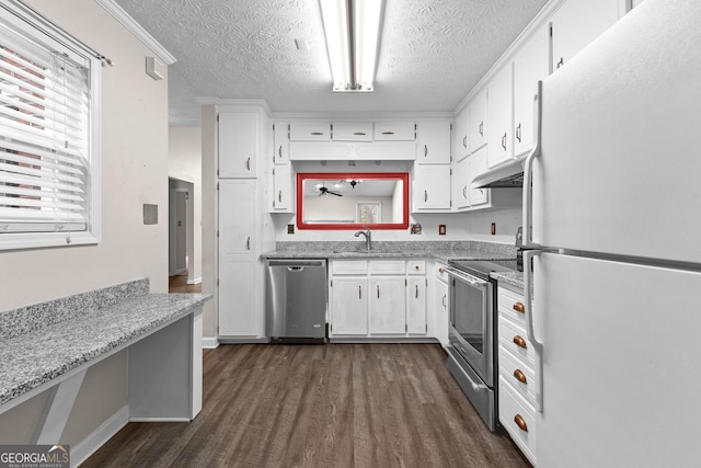 kitchen with white cabinets, a textured ceiling, stainless steel appliances, dark wood-type flooring, and under cabinet range hood