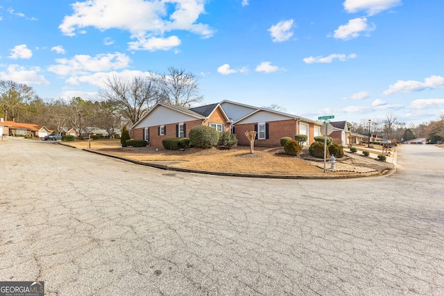 ranch-style home featuring brick siding