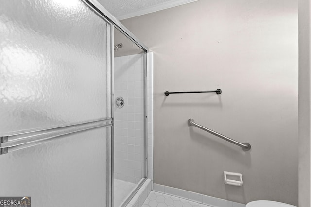 bathroom featuring toilet, an enclosed shower, and tile patterned flooring