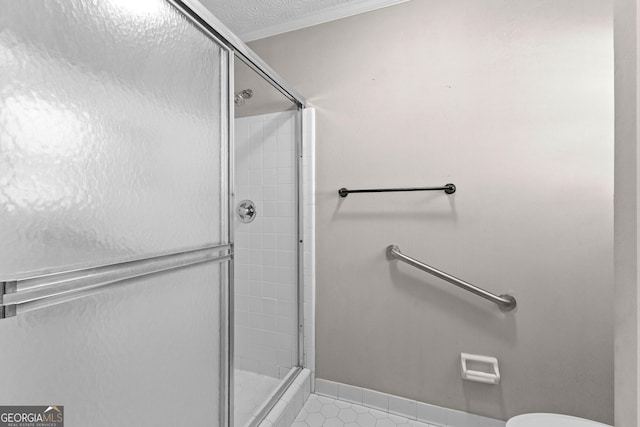 full bathroom with tile patterned floors, a stall shower, and toilet