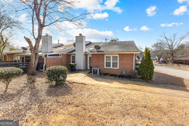 rear view of house featuring a patio and central AC