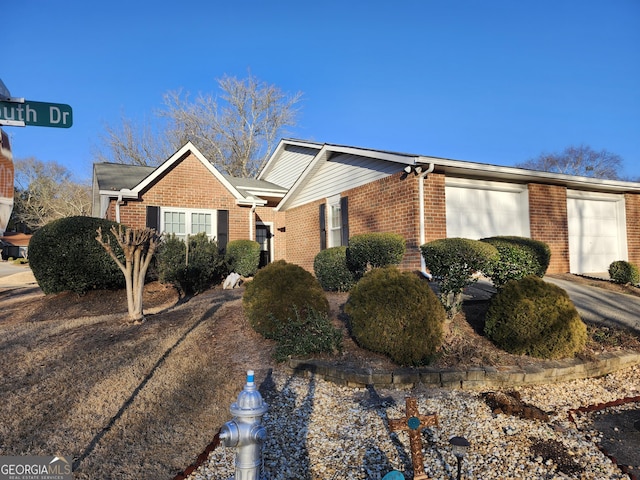 view of front of property featuring an attached garage and brick siding