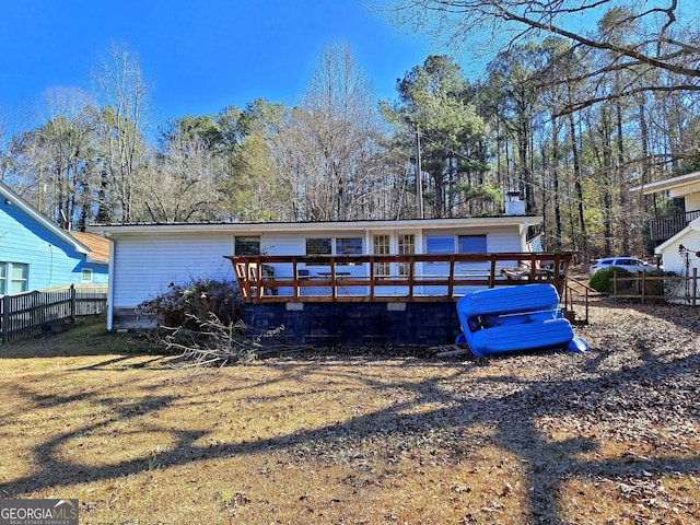 rear view of house featuring a wooden deck