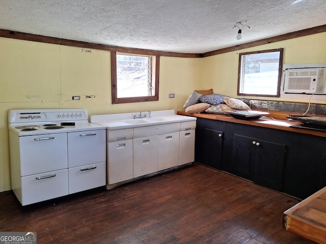 kitchen with sink, dark hardwood / wood-style floors, a textured ceiling, white cabinets, and an AC wall unit