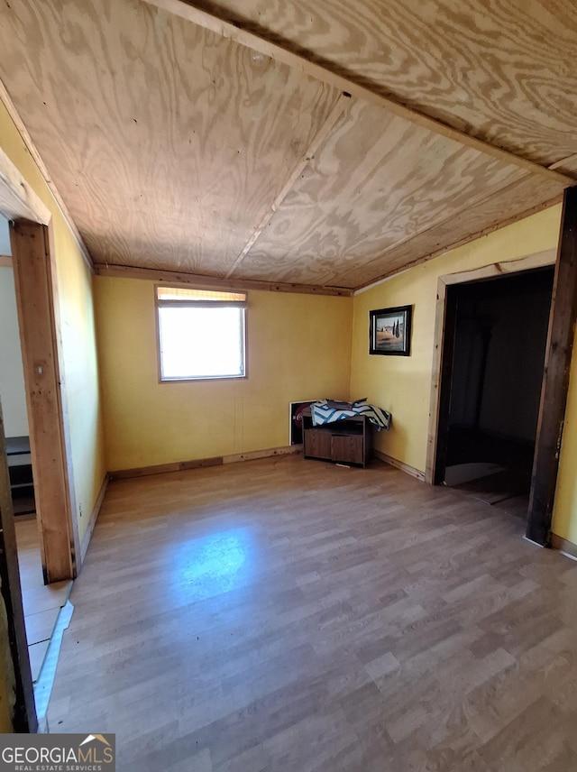 interior space featuring wood-type flooring and wooden ceiling