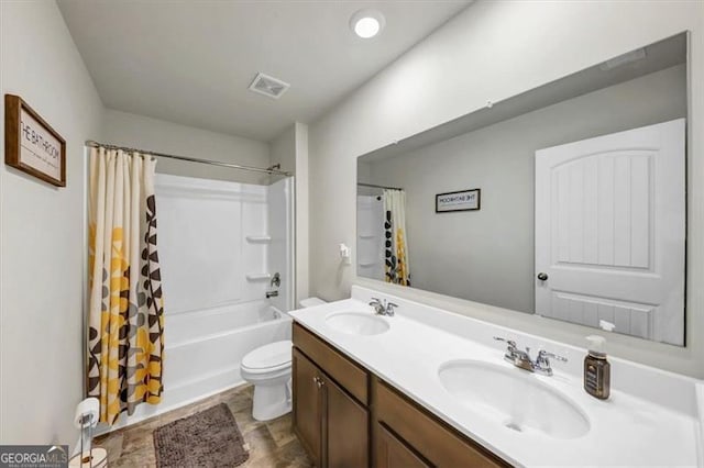 8819 Sibella Ct, Lithia Springs, GA 30122 - full bathroom with double vanity, toilet, and shower / bath combo with shower curtain