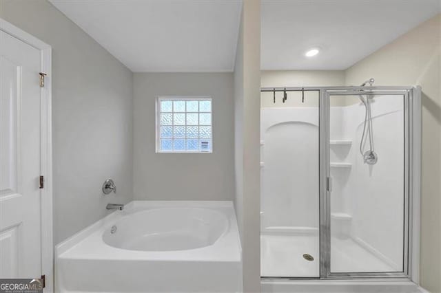 bathroom with shower with separate bathtub