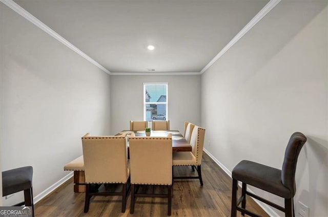 dining space with crown molding and dark hardwood / wood-style floors