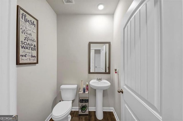 bathroom featuring sink, hardwood / wood-style flooring, and toilet