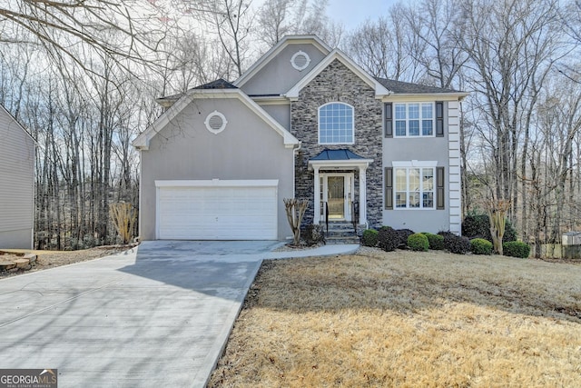 view of front facade with driveway, stone siding, an attached garage, and stucco siding