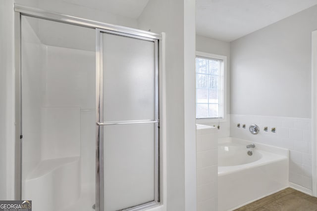 bathroom with separate shower and tub