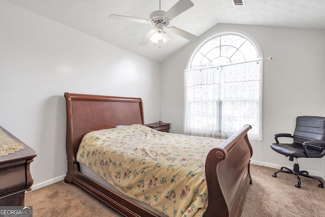 carpeted bedroom featuring lofted ceiling, multiple windows, and a textured ceiling