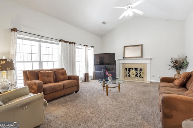 living room featuring carpet floors, high vaulted ceiling, a premium fireplace, and ceiling fan